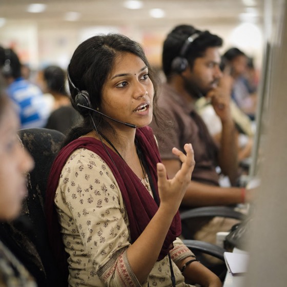 A telesales agent at a row of desks